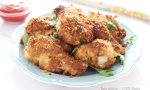 Alette di pollo croccanti in friggitrice ad aria, servite su un piatto azzurro con prezzemolo fresco e una ciotolina di ketchup.