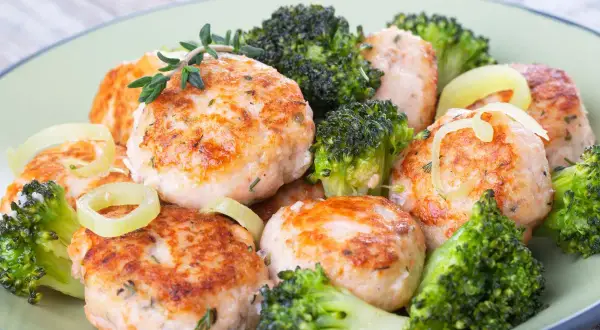Deliziose polpette di merluzzo dorate, servite con cimette di broccoli croccanti e anelli di cipolla. Un piatto sano e gustoso.