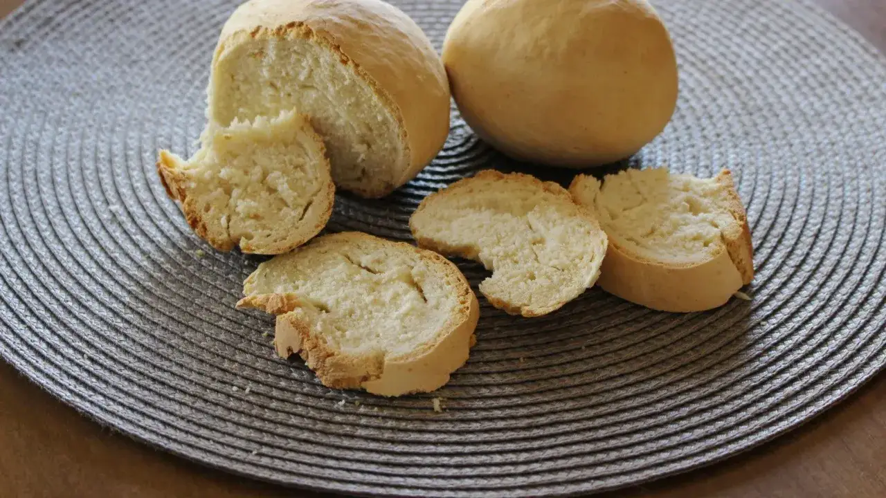 Pane casereccio con lievito istantaneo, tagliato a fette su un sottobicchiere intrecciato.